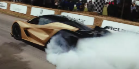 lotus evija doing a burnout on the goodwood track