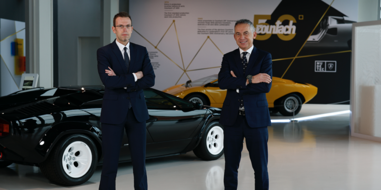 Rouven Mohr and Maurizio Reggiani standing in front of a classic lamborghini countach