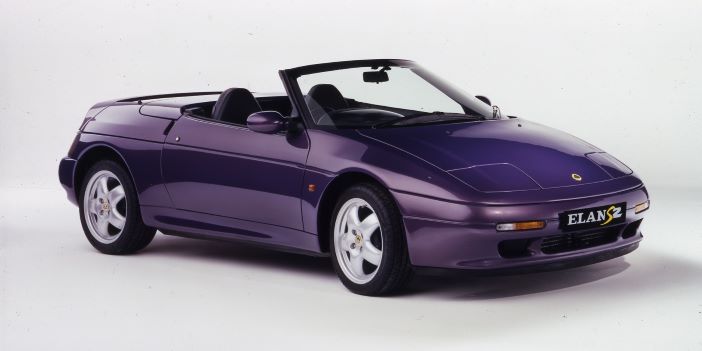 A purple lotus elan s2 with the roof down