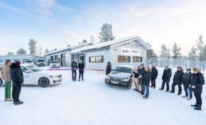 Guests at the opening of Apollo Tyres' outdoor testing facility in Ivalo, Sweden. The single-storey white building is in a snowy landscape