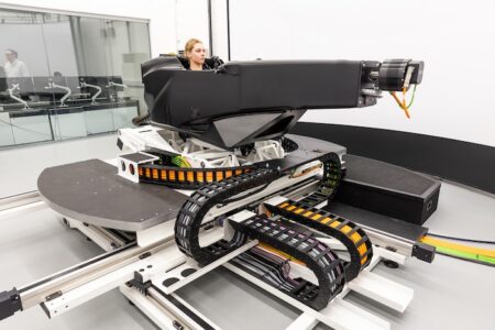 IAAPS brings in DiL simulator for dynamics and propulsion development A female using the Ansible Motion Delta S2 simulator in a test laboratory